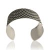 front view of a silver cuff with oxidised design