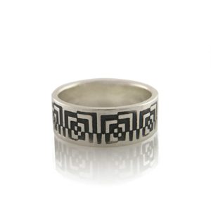 Unisex ring bad in silver laying flat on white background