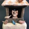 ceramic sculpture of house with cat and birds