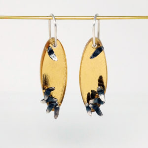 A Mummering Flock golden oval earrings