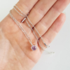 Handmade Custom Cubic Zirconia Solitaire Pendant Necklace is hanging on the palm.