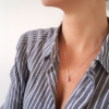 Handmade Custom Cubic Zirconia Solitaire Pendant Necklace is worn on the woman worn in a striped shirt