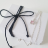Handmade Custom 7mm Cubic Zirconia Solitaire Pendant is placed on the white paper gift box tied with black cotton string.