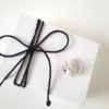 Minimalist Silver CZ Statement Ring is shown on white gift box tied with black cotton string.