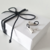 Hand-carved Minimalist Silver Patina Stud Earrings is shown on the white paper gift box tied with black cotton string.