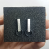 Hand-carved Minimalist Silver Patina Stud Earrings is shown on the black foam holder.