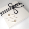 Sterling silver Statement earrings are placed on the white gift box tied with black cotton string.