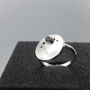 Minimalist Silver CZ Circle Ring is placed on the black sponge.