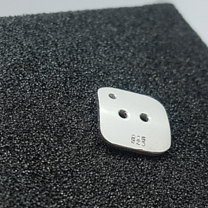 Artisan Custom Minimalist Silver Cubic Zirconia Apparel Button (back side) is placed on the black foam block.