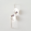 Handmade Silver CZ Circle Drop Earrings are placed on the white surface.