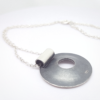 Artisan oxidised sterling Silver pendant necklace (back side) is shown on a white surface.