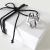 Artisan Geometric Patina Statement Ring in Sterling Silver is displayed on the white gift box tied with black cotton rope.