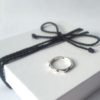 Sterling silver ring with six Cabochon Sapphires is placed on the white gift box tied with black cotton string.