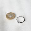 Sterling silver ring with six Cabochon Sapphires is placed next to one pound on the white surface.