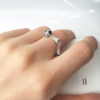Asymmetrical Square Silver Ring with 8 Cubic Zirconias is shown on the middle finger.