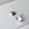 Circle Silver Stud Earrings on a white surface.