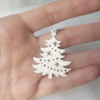 Silver Christmas Tree Hanging Ornament on the palm.