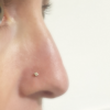 Artisan cubic nose stud on a nose.