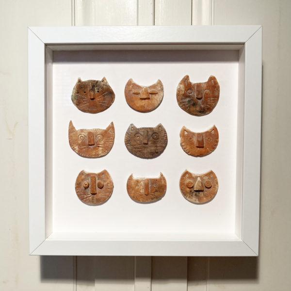 nine ceramic cat faces