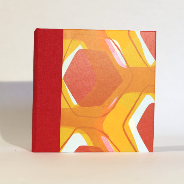 front of square book in red and yellow